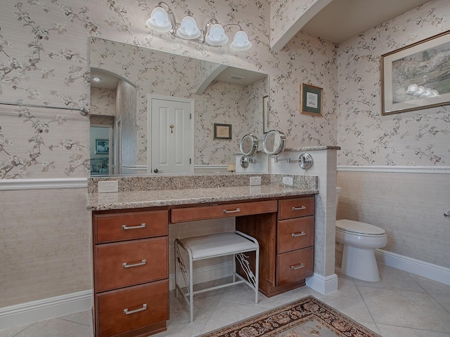 bathroom with tile patterned flooring, vanity, and toilet