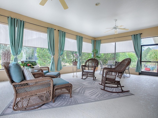 sunroom featuring ceiling fan and plenty of natural light