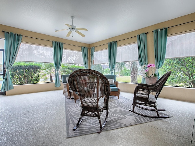 sunroom / solarium featuring a wealth of natural light and ceiling fan