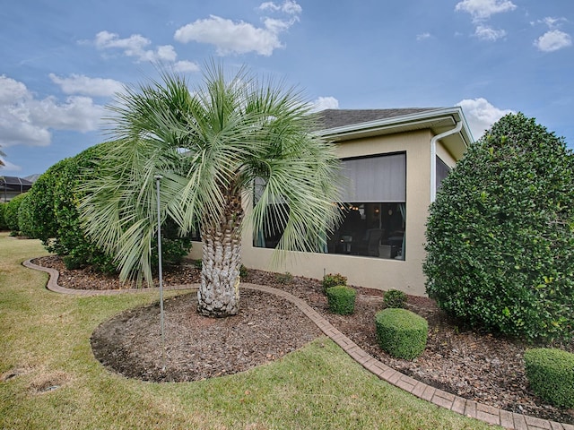 view of property exterior featuring a lawn and stucco siding