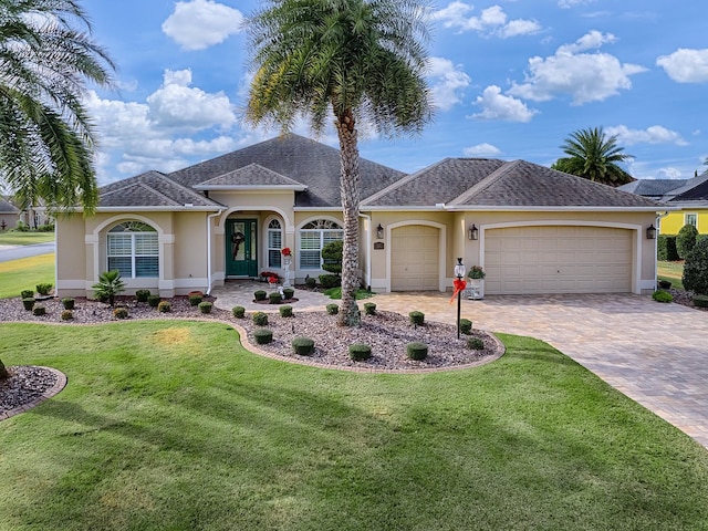 ranch-style house with a front yard and a garage