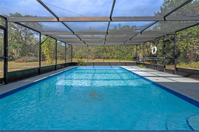 view of swimming pool featuring a lanai