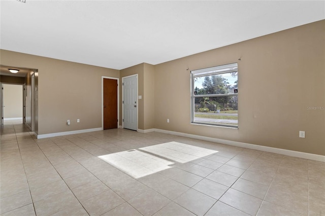 unfurnished room with light tile patterned flooring