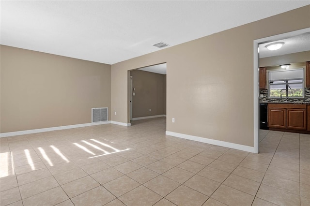 tiled spare room with sink