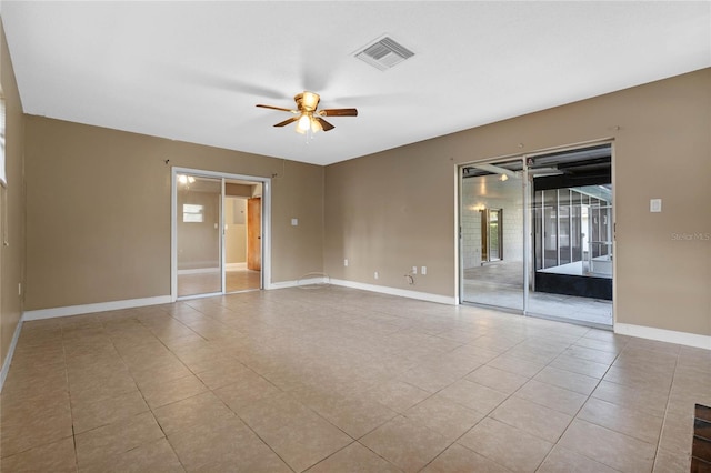 tiled spare room featuring ceiling fan