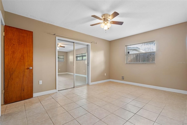 unfurnished bedroom featuring light tile patterned floors, a closet, and ceiling fan