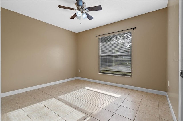 spare room with ceiling fan and light tile patterned flooring