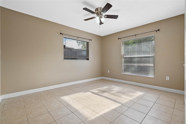 unfurnished room with ceiling fan and light tile patterned floors