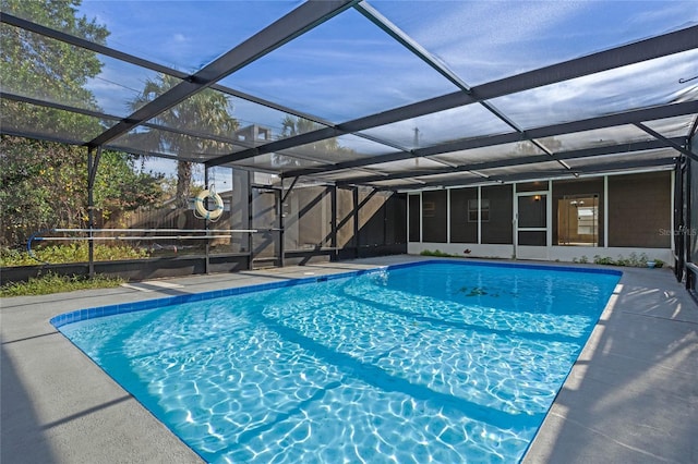 view of pool with glass enclosure