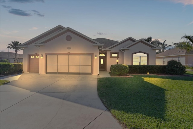 view of front of house with a lawn and a garage