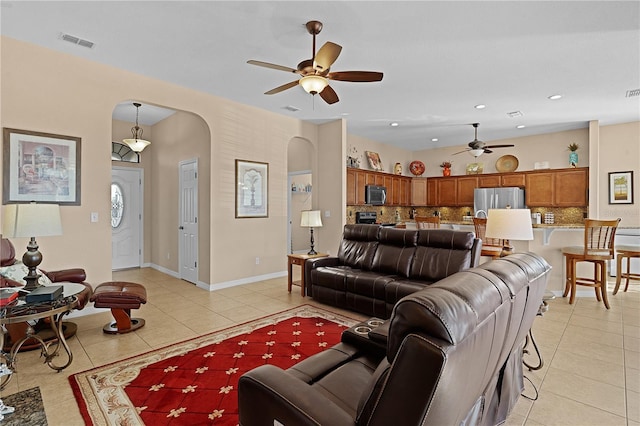 tiled living room featuring ceiling fan