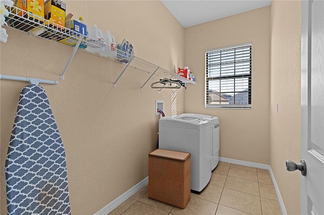 washroom with light tile patterned floors and independent washer and dryer