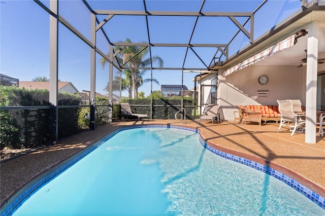 view of pool featuring a lanai, ceiling fan, and a patio area