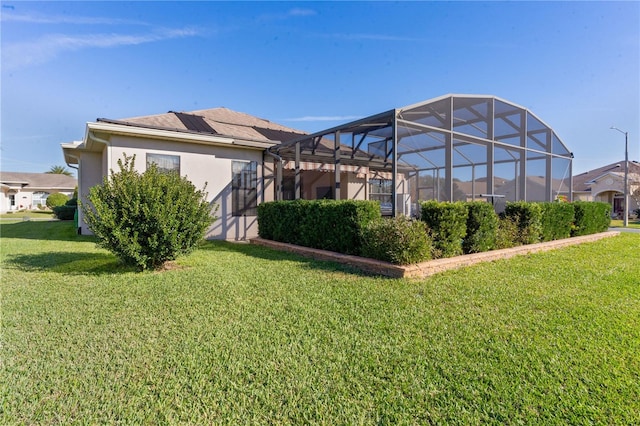 exterior space featuring a yard and a lanai