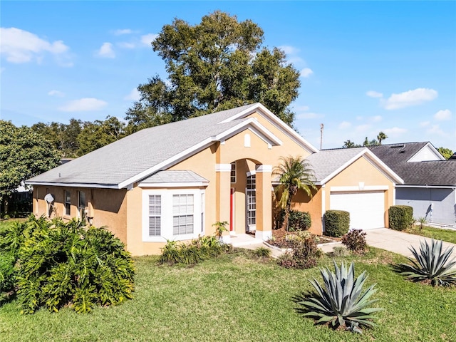 view of front facade featuring a front lawn and a garage