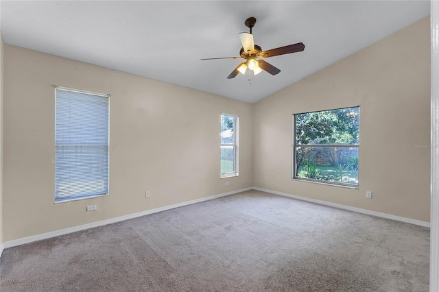 empty room featuring ceiling fan, light colored carpet, and lofted ceiling