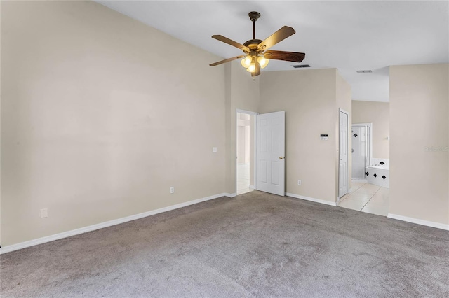 carpeted empty room with ceiling fan and lofted ceiling