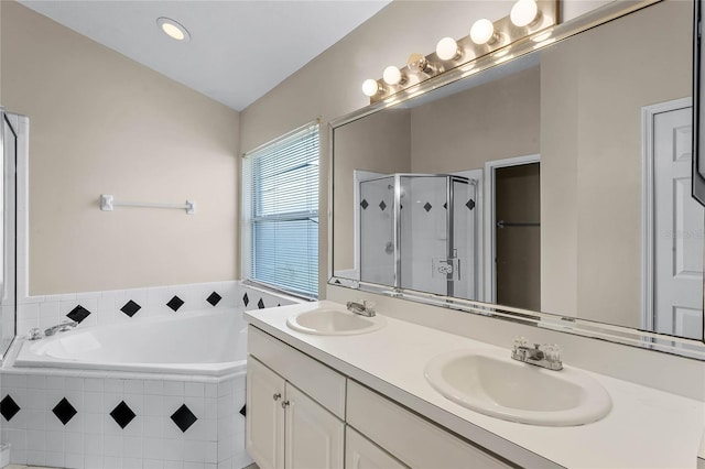 bathroom with vanity and shower with separate bathtub