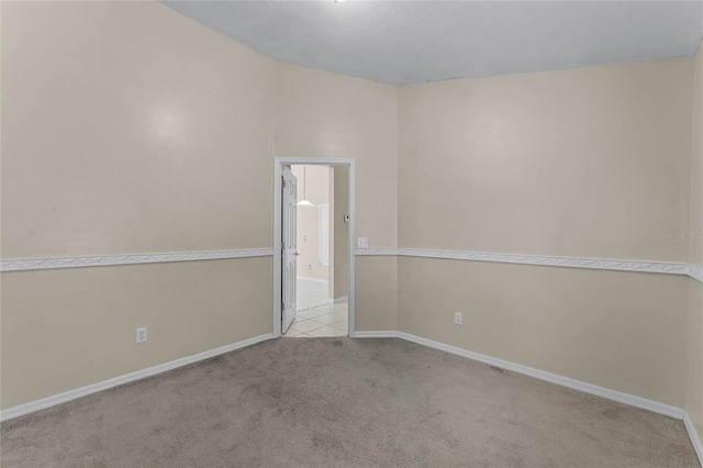 spare room featuring light colored carpet