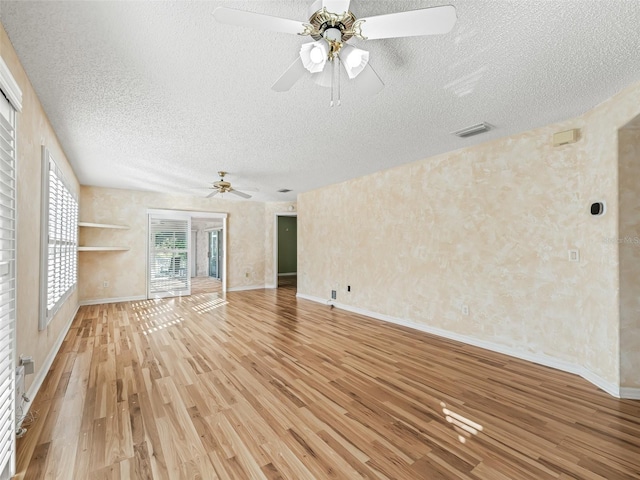 unfurnished living room with hardwood / wood-style floors, ceiling fan, and a textured ceiling