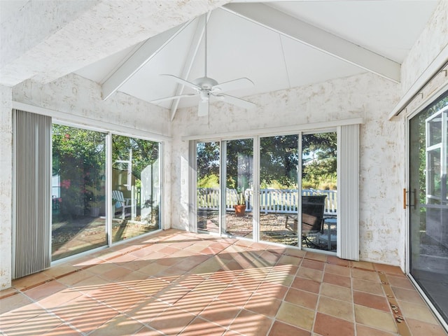 unfurnished sunroom featuring vaulted ceiling with beams, plenty of natural light, and ceiling fan