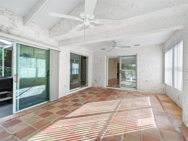 unfurnished sunroom with ceiling fan and lofted ceiling with beams