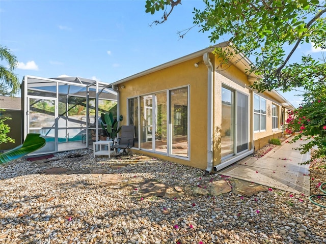 view of side of property featuring a lanai