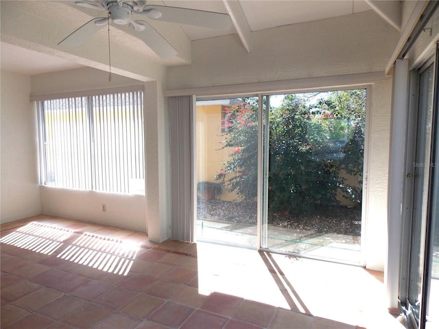 tiled spare room with a ceiling fan and a healthy amount of sunlight