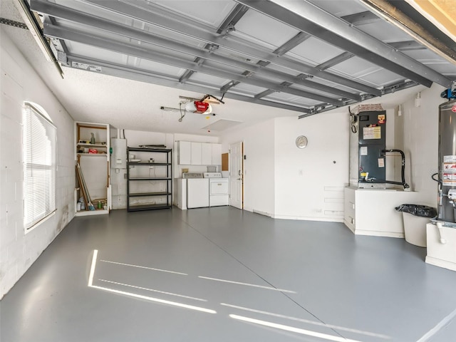 garage with heating unit, washer and dryer, and a garage door opener