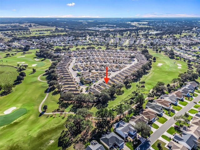 birds eye view of property with view of golf course and a residential view