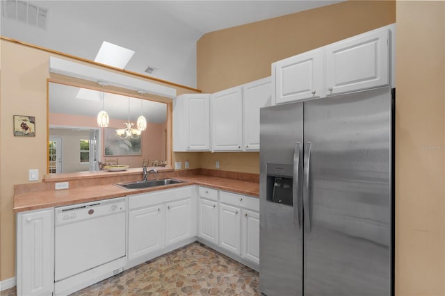 kitchen featuring white cabinetry, sink, stainless steel fridge with ice dispenser, white dishwasher, and pendant lighting