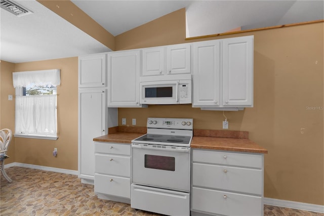 kitchen with lofted ceiling, white cabinetry, and white appliances