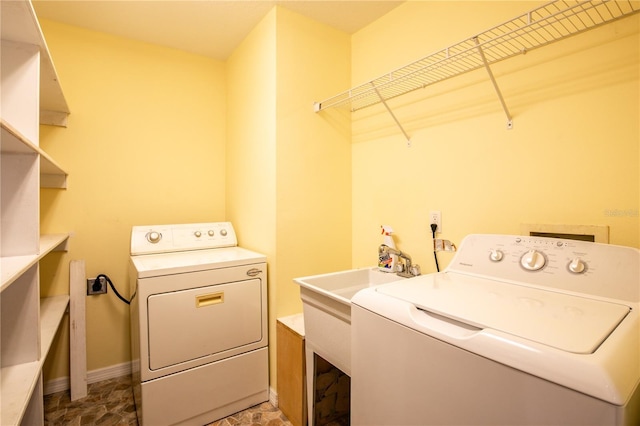 laundry room featuring washer and clothes dryer and sink