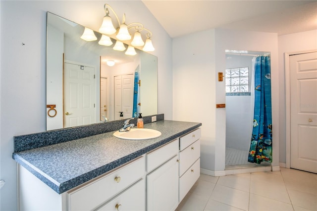 bathroom with tile patterned floors, vanity, and curtained shower