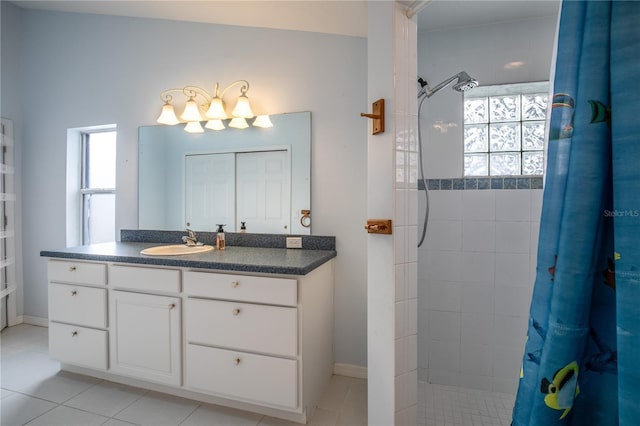 bathroom with tile patterned floors, vanity, and curtained shower