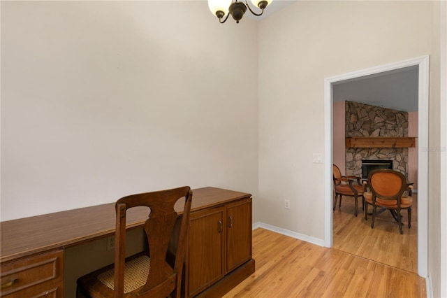 office area featuring a fireplace and light hardwood / wood-style floors