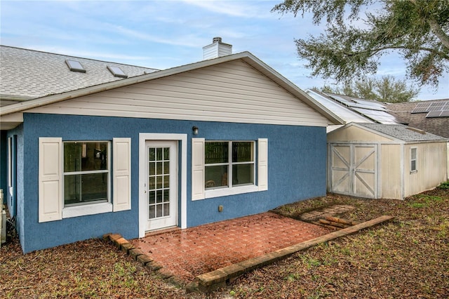 back of property featuring a shed