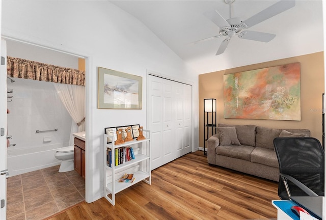 interior space with hardwood / wood-style flooring, ceiling fan, and vaulted ceiling