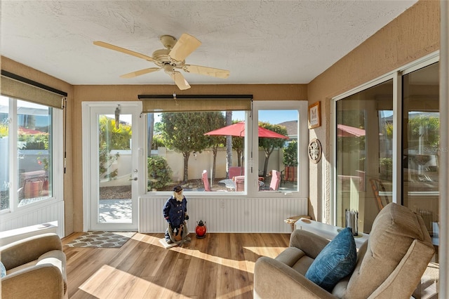 sunroom / solarium featuring ceiling fan