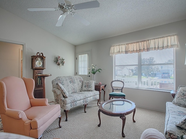 carpeted living room with lofted ceiling, a textured ceiling, ceiling fan, and plenty of natural light