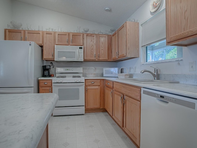 kitchen with white appliances, a textured ceiling, vaulted ceiling, and sink