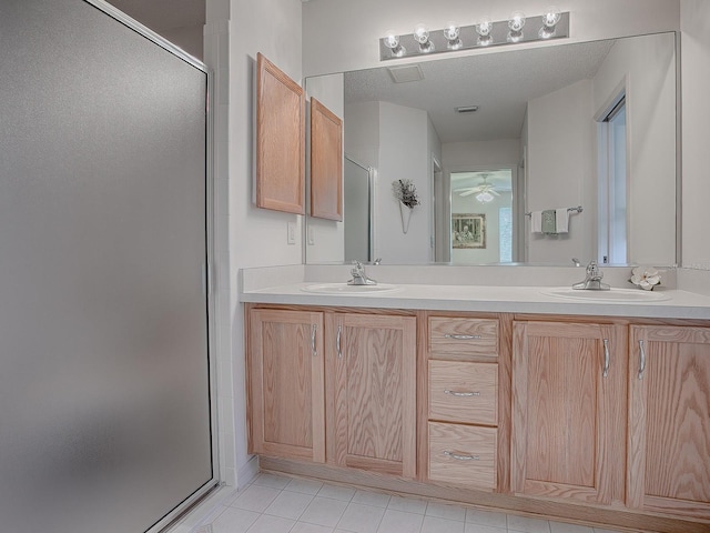 bathroom with vanity, walk in shower, and tile patterned flooring