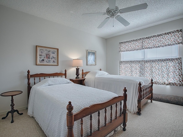 carpeted bedroom with a textured ceiling and ceiling fan