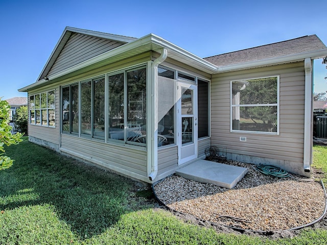 view of home's exterior featuring a sunroom