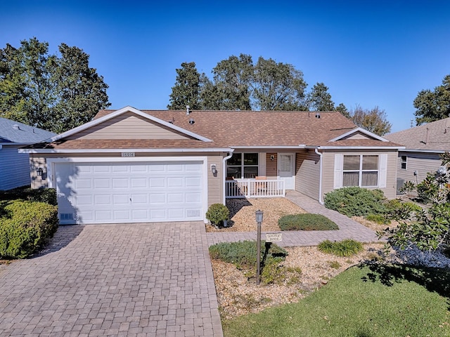 single story home with a garage and covered porch