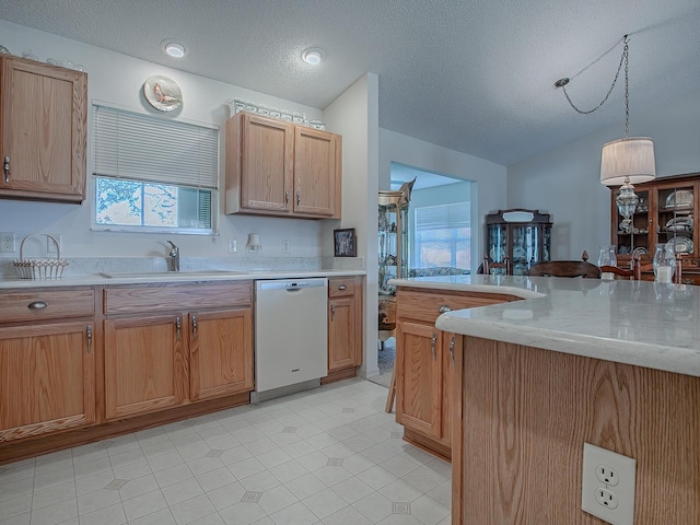 kitchen with sink, decorative light fixtures, a textured ceiling, light stone counters, and white dishwasher