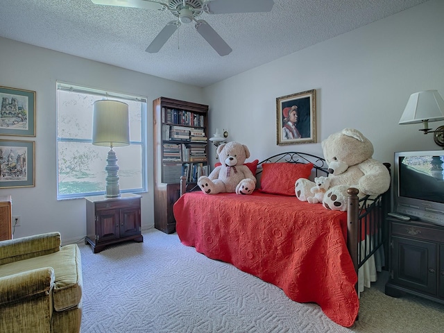 carpeted bedroom with multiple windows, a textured ceiling, and ceiling fan