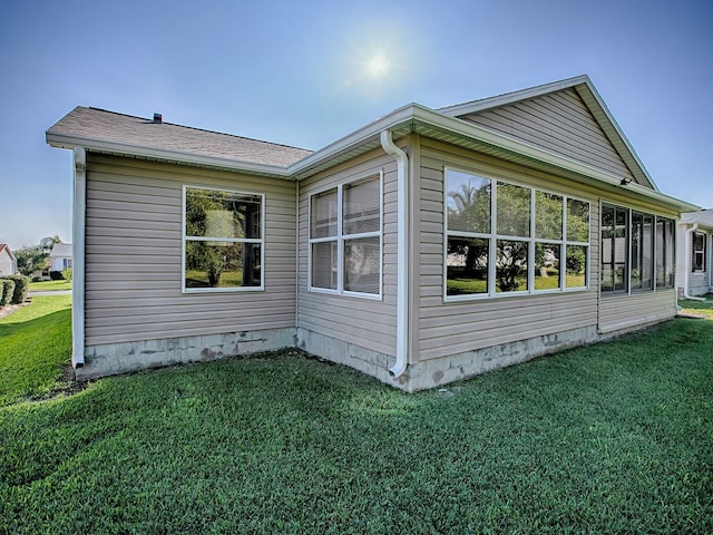 view of side of property with a lawn