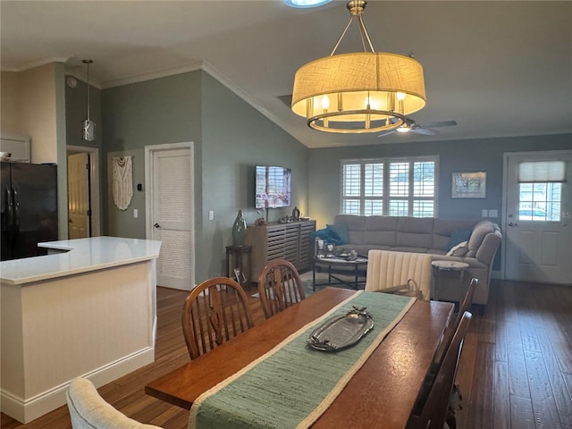 dining room featuring ceiling fan, dark wood-type flooring, crown molding, and lofted ceiling