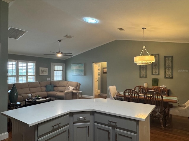 kitchen with dark wood-type flooring, hanging light fixtures, lofted ceiling, and a kitchen island